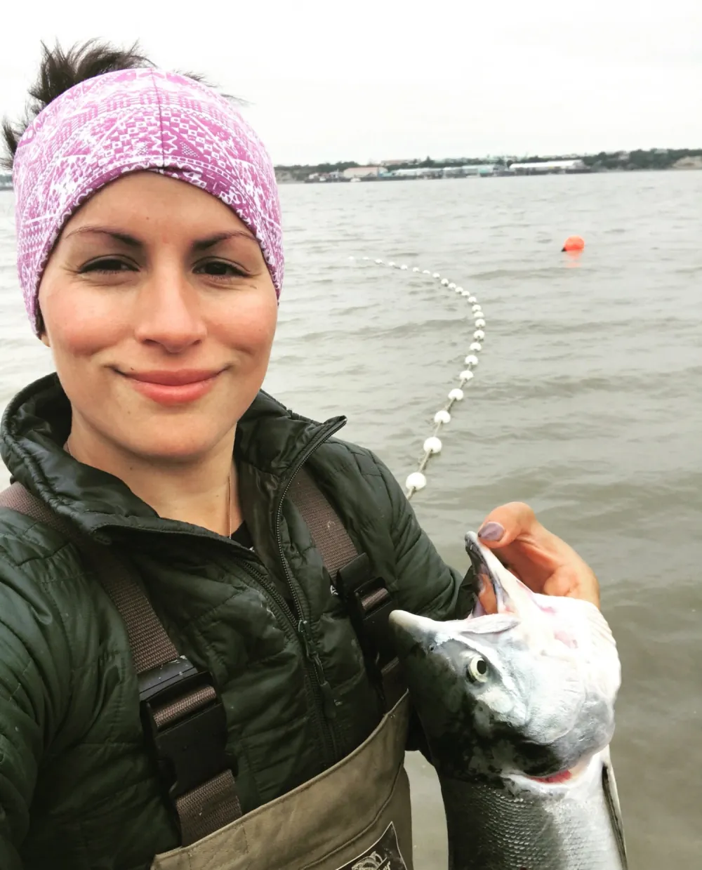Michelle holding a fresh sockeye at the setnet in Bristol Bay